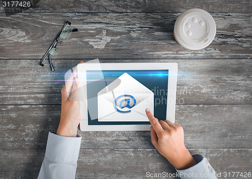 Image of close up of hands with tablet pc and e-mail