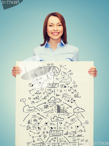 Image of smiling businesswoman with plan in white board