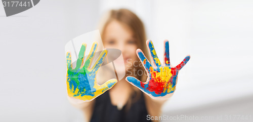 Image of girl showing painted hands