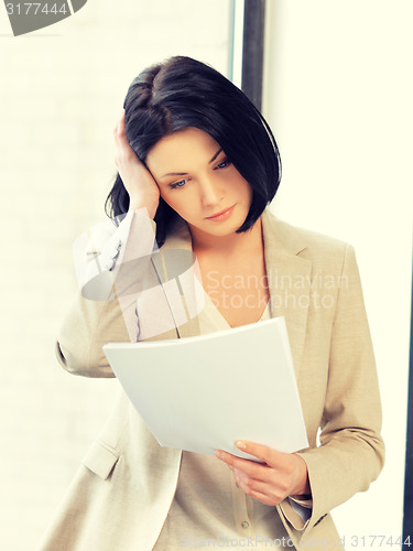 Image of calm woman with documents