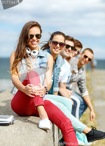 Image of teenage girl hanging out with friends outdoors