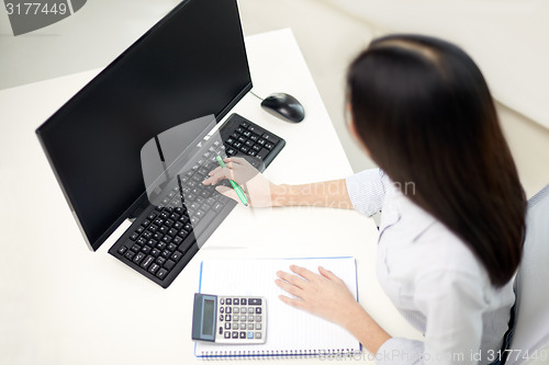 Image of close up of woman with calculator counting