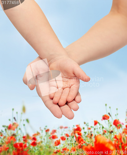 Image of close up of woman and little child hands together