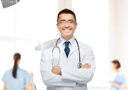 Image of smiling male doctor in white coat at hospital