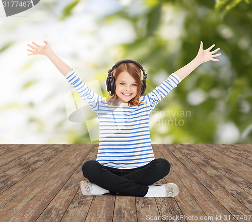 Image of happy girl with headphones listening to music