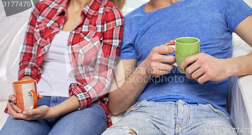 Image of close up of couple relaxing on sofa in new home