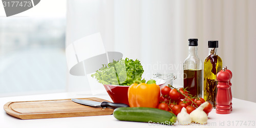 Image of vegetables, spices and kitchenware on table