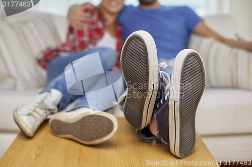 Image of close up of couple relaxing on sofa in new home