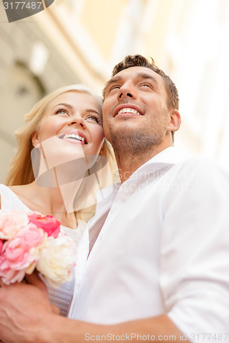 Image of couple with flowers in the city