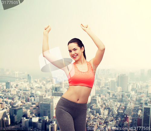 Image of smiling teenage girl in sportswear dancing