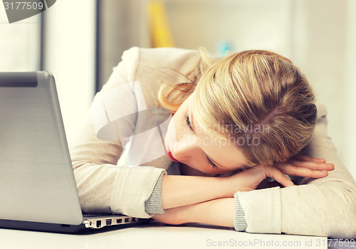 Image of tired woman with laptop computer