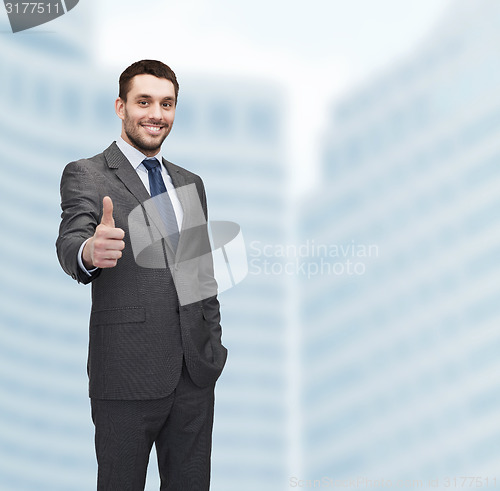 Image of handsome buisnessman showing thumbs up