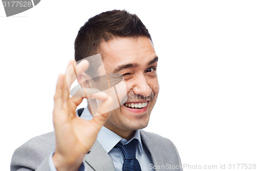 Image of happy businessman in suit showing ok hand sign