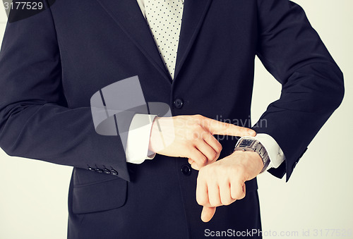 Image of man looking at wristwatch