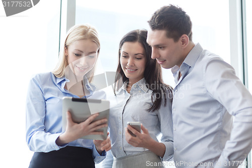 Image of business team working with tablet pcs in office