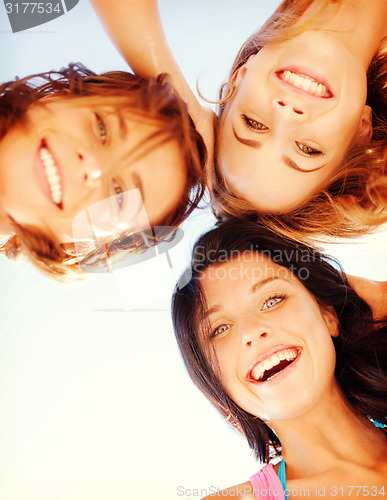 Image of girls faces with shades looking down