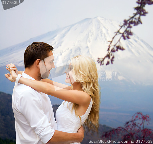 Image of happy couple hugging over japan mountains