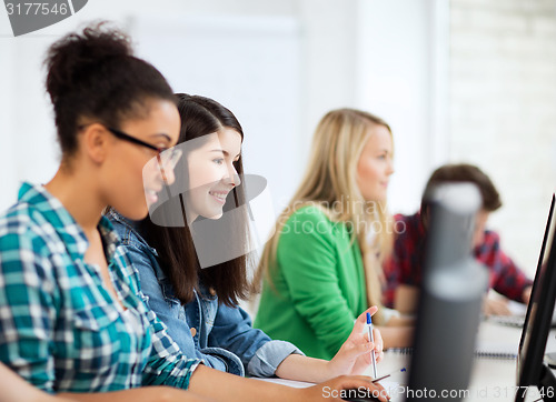 Image of students with computers studying at school