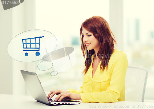 Image of smiling woman with laptop computer shopping online