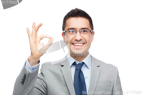 Image of happy smiling businessman in eyeglasses and suit