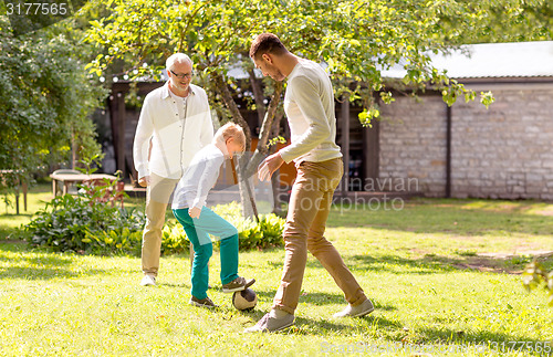 Image of happy family playing football outdoors