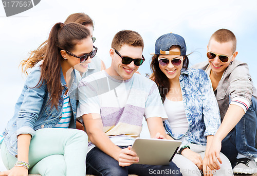 Image of group of teenagers looking at tablet pc