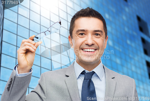 Image of happy smiling businessman in eyeglasses and suit