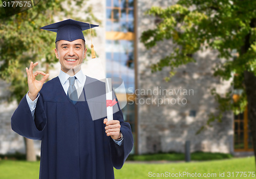 Image of smiling adult student in mortarboard with diploma