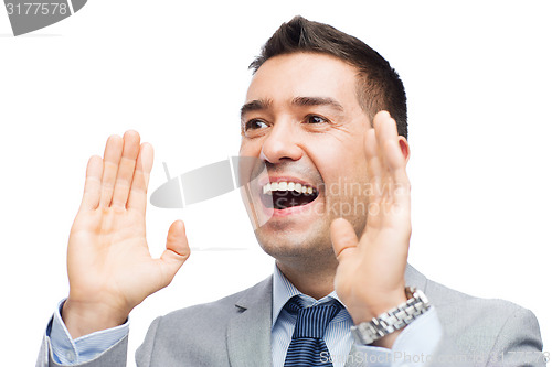 Image of happy businessman in suit shouting