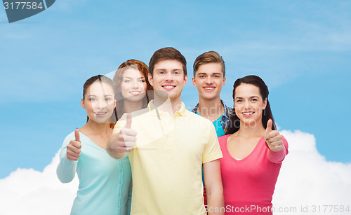 Image of group of smiling teenagers showing thumbs up