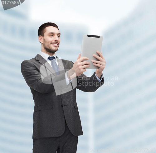 Image of smiling buisnessman with tablet pc computer