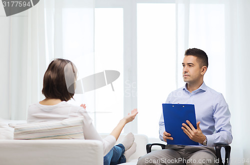 Image of doctor and young woman meeting at home visit
