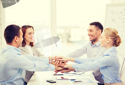 Image of business team celebrating victory in office