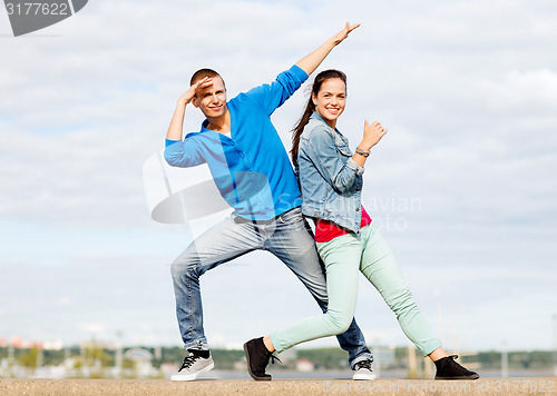 Image of couple of teenagers dancing outside