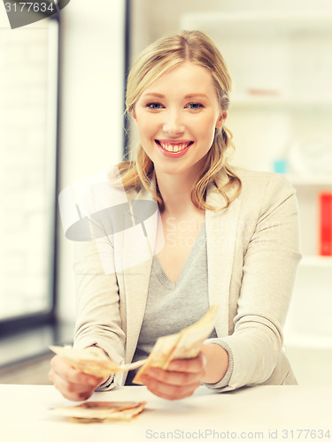 Image of lovely woman counting euro cash money