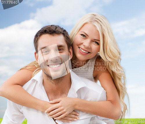 Image of couple having fun over sky and grass background