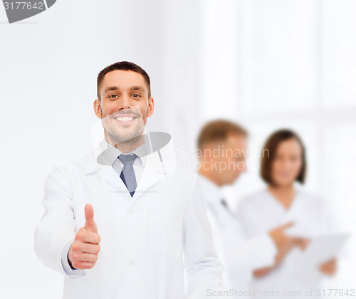 Image of smiling male doctor showing thumbs up