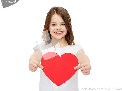 Image of smiling little girl giving red heart