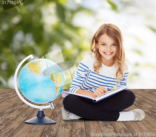 Image of girl with globe and book