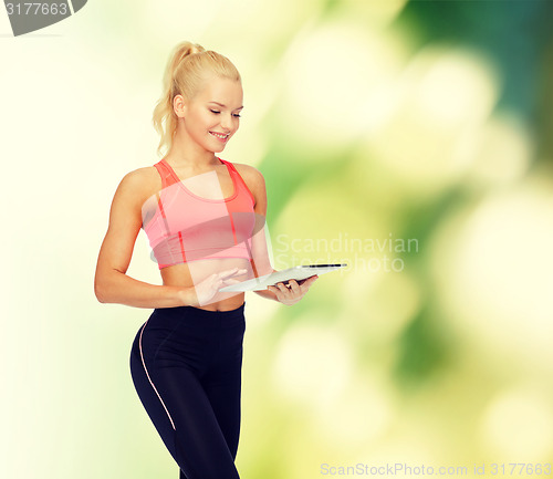 Image of smiling sporty woman with tablet pc computer