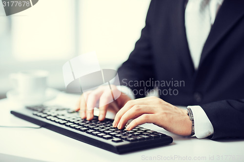 Image of man hands typing on keyboard