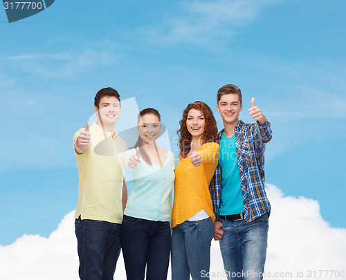Image of group of smiling teenagers showing thumbs up