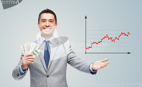 Image of smiling businessman with american dollar money