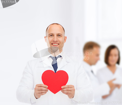 Image of smiling male doctor with red heart