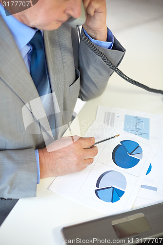 Image of close up of senior businessman calling on phone