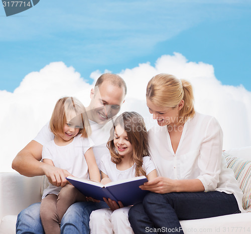 Image of happy family with book at home