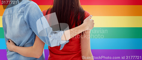 Image of close up of happy lesbian couple hugging at home
