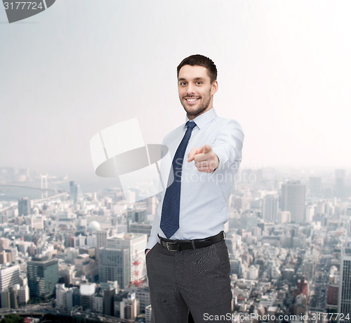 Image of handsome businessman pointing finger at you