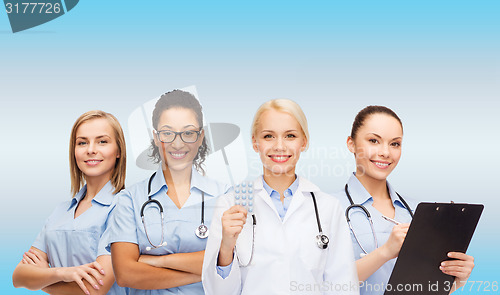 Image of smiling female doctor and nurses with stethoscope