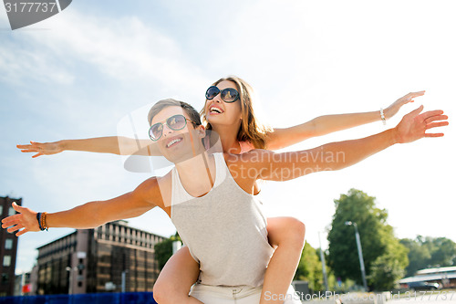 Image of smiling couple having fun in city